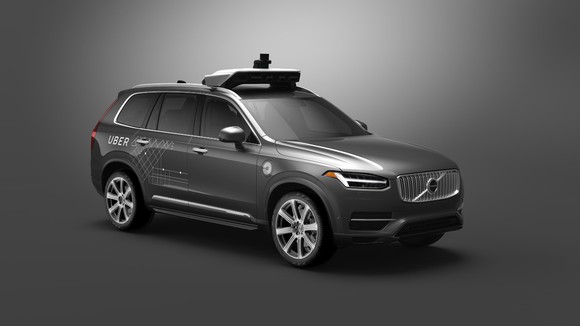 A gray Volvo XC90, a large crossover SUV, with Uber logos and visible self-driving sensor hardware.