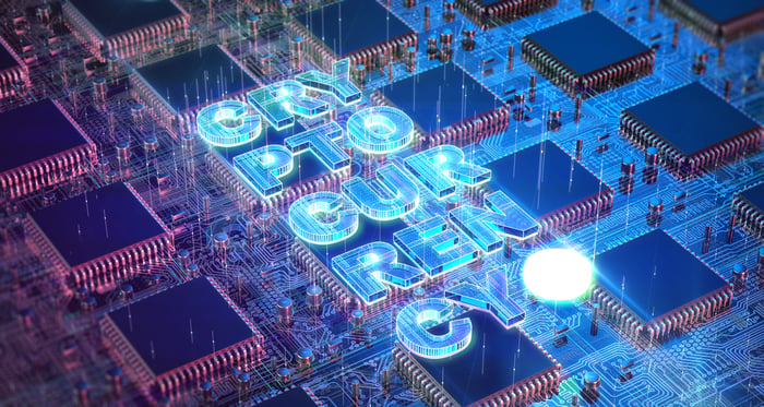 The word cryptocurrency written across a multiple ASIC chips and circuitry. 