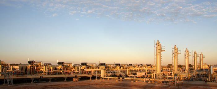 A set of compressors, pipelines and natural gas distribution centers in a rural area.