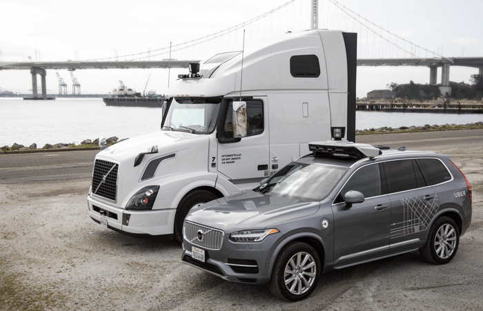 A freight truck and Volvo SUV parked side by side.