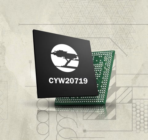 Cypress new bluetooth mesh chip, a small chip encased in a small black box with the company's logo of a cypress tree on the front.