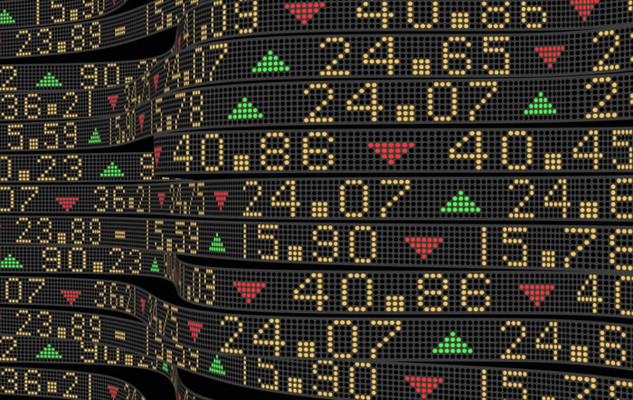 A stock market digital ticker showing prices rising and falling.