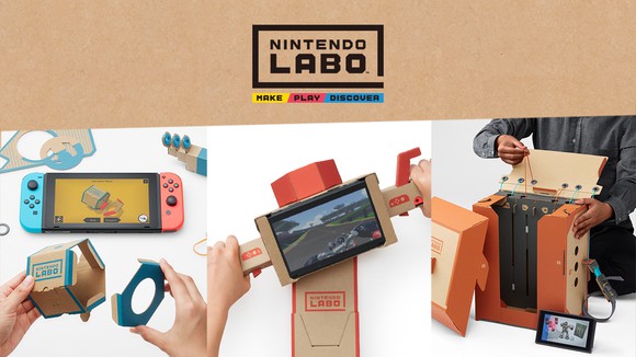 Hands playing with the Switch system and cardboard pieces under the Nintendo product logo.