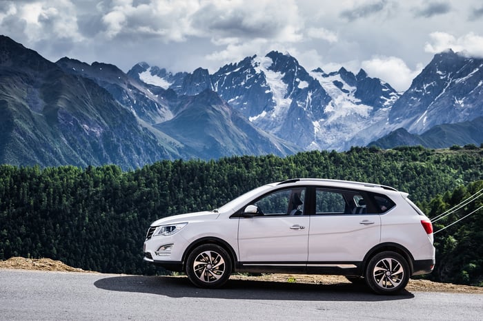 A white Baojun 560 SUV, with mountains in the background