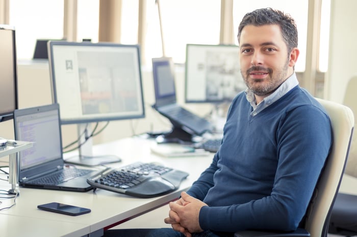 Smiling man at an office desk