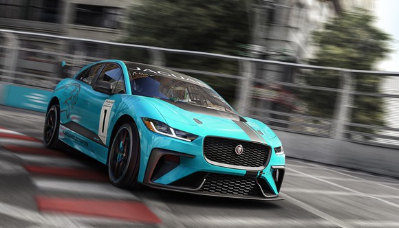 A bright blue Jaguar I-Pace, an electric SUV, is shown on a racing track.