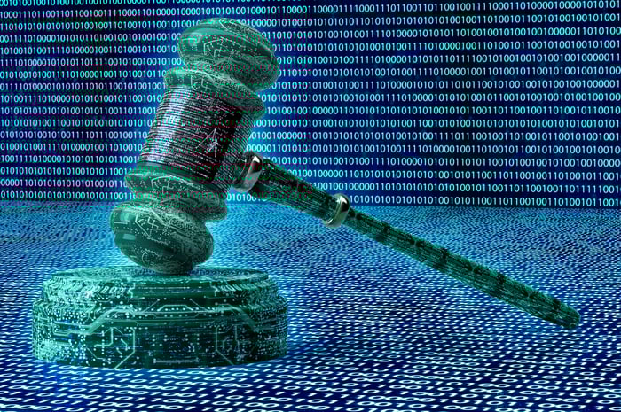 A judge's gavel surrounded by binary code.