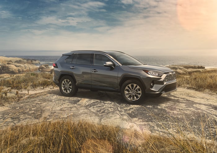 A dark silver 2019 RAV4 in a rocky field.