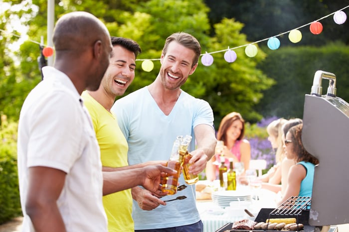 Friends drinking beer at party 