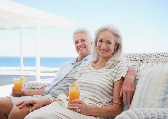 Senior couple holding cocktails outdoors