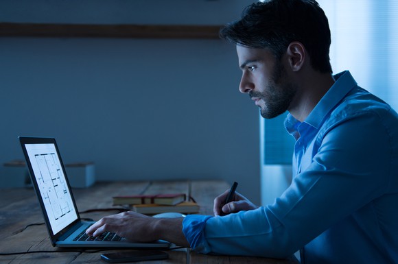 Man working on a laptop in the dark