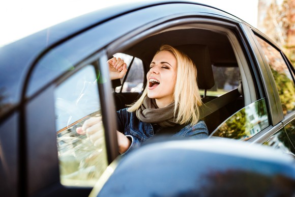 Woman singing in a car