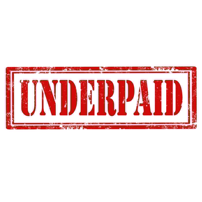 Underpaid stamped in red letters on a white background