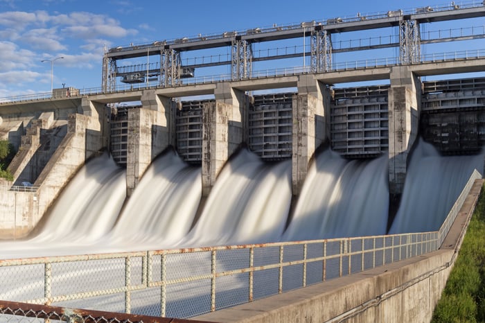 Water rushing through the gates of a hydroelectric station. 