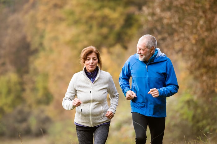 Senior couple running outdoors