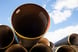 A stack of pipelines with a blue sky in the background.