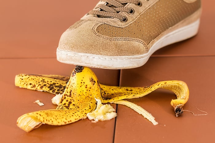 A closeup of a sneaker about to step on a banana peel