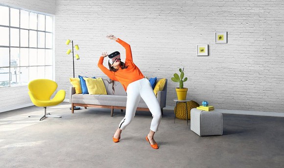 A woman using Lenovo's Mirage Solo VR headset.