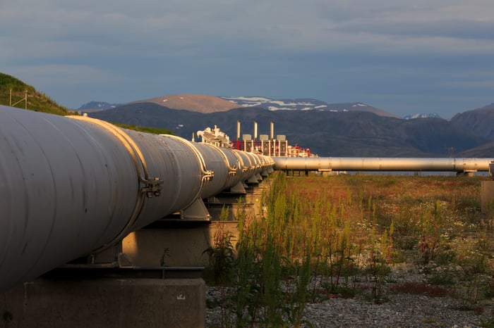 A pipeline with mountains in the background.