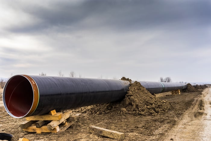 A pipeline under construction with a cloudy sky above.