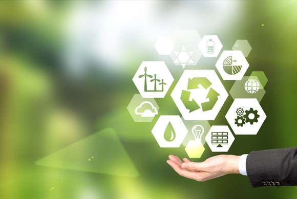 Renewable energy icons hovering over an outstretched hand.