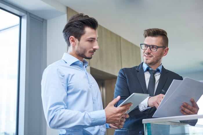 Two professional men looking at documents