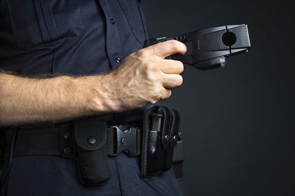An officer holding a taser.