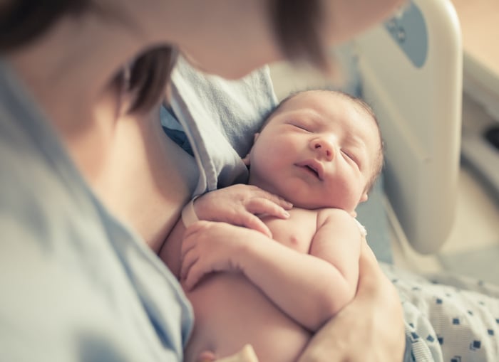 Woman holding sleeping infant
