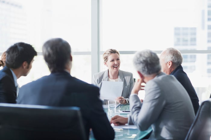 Professionals sitting at a conference table having a meeting.