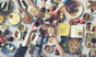 friends sitting around table in restaurant and toasting food drink dining