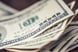A close-up of a stack of $100 bills.
