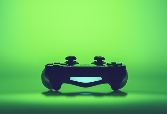 Video game controller with a green background