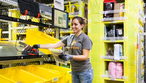 An Amazon employee in an Amazon warehouse.