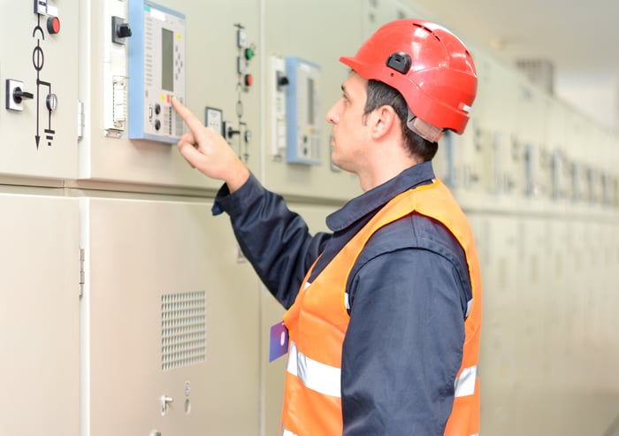 A man checking electrical industrial equipment