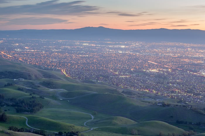 view of Silicon Valley at dusk with lights on.