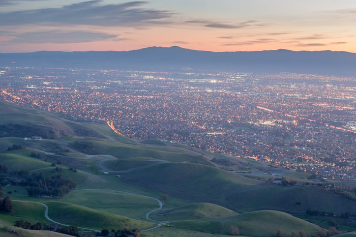 view of Silicon Valley at dusk with lights on. 