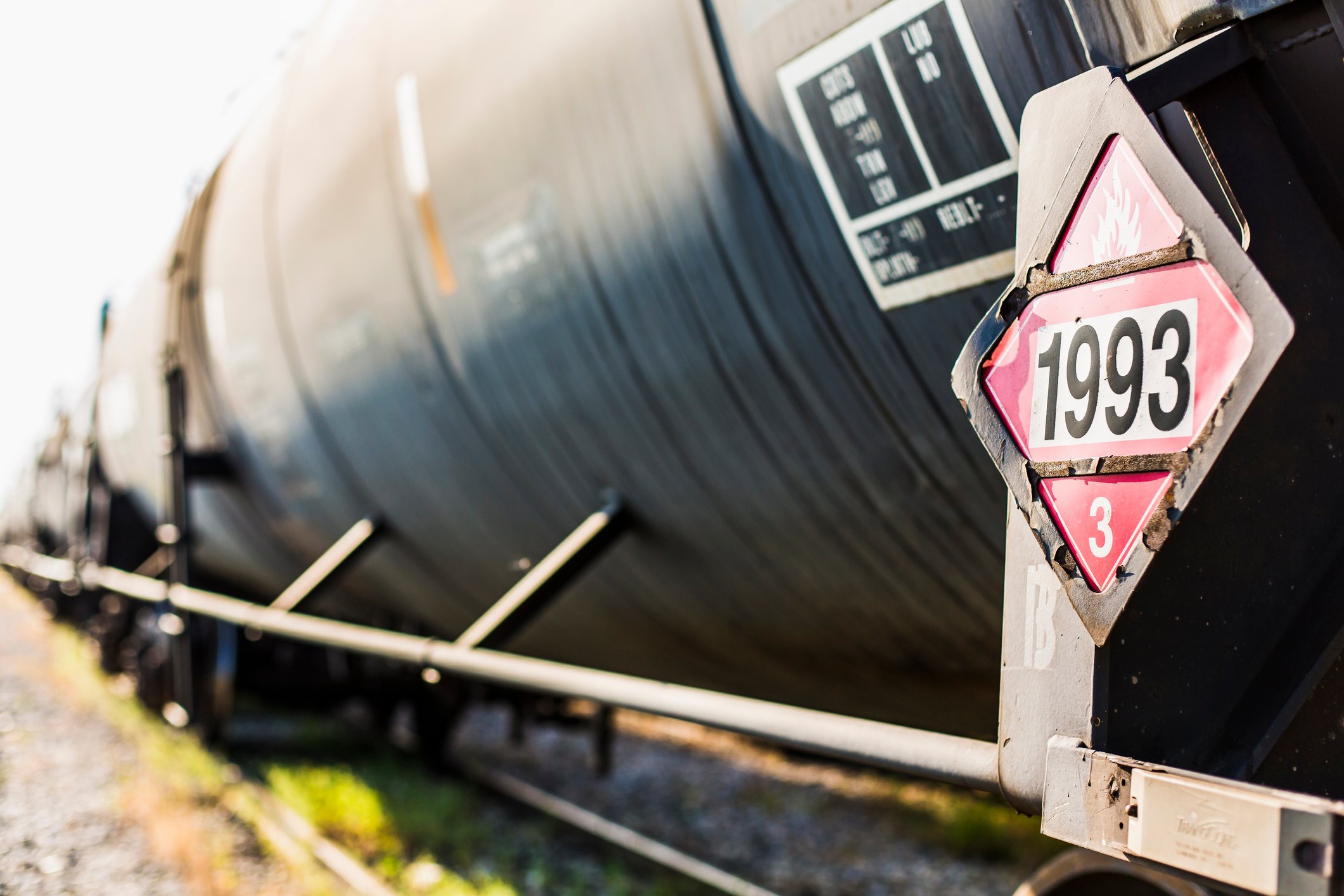 A closeup of an oil tank car focused on a hazardous material sign 1993 denoting flammable liquids.