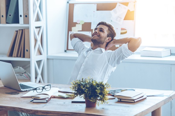 Relaxed-looking man at a desk.