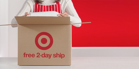A person putting an item in a box with the target logo and free 2-day ship printed on it.