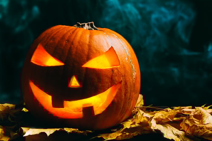 A carved pumpkin with a devious face.