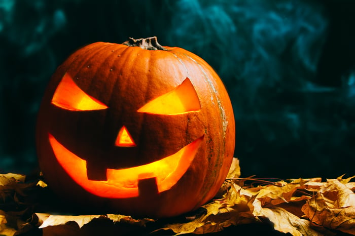 A carved pumpkin with a devious face. 