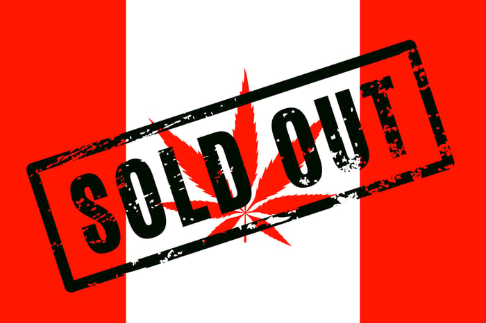 A Canadian flag with a cannabis leaf instead of a maple leaf, with the stamped words, Sold Out, emblazoned on the front. 