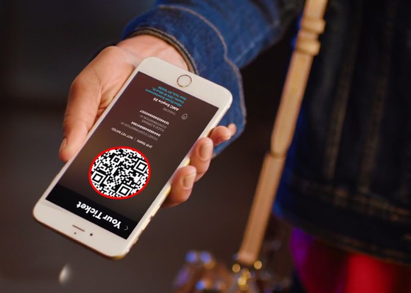 Man holding smartphone displaying AMC Stubs A-List app