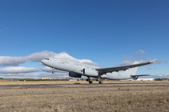 Airbus A330 tanker taking off from runway.