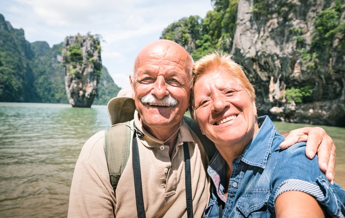 Smiling senior couple out on a body of water