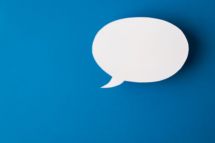 An illustration of a blank white speech bubble is shown against a blue background.