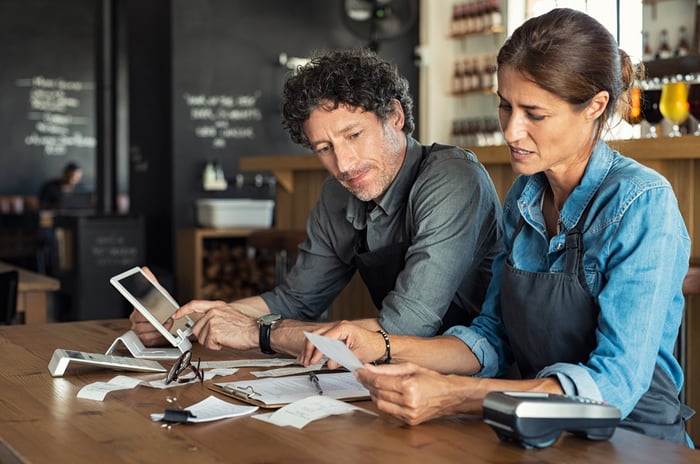 Man and woman going through receipts