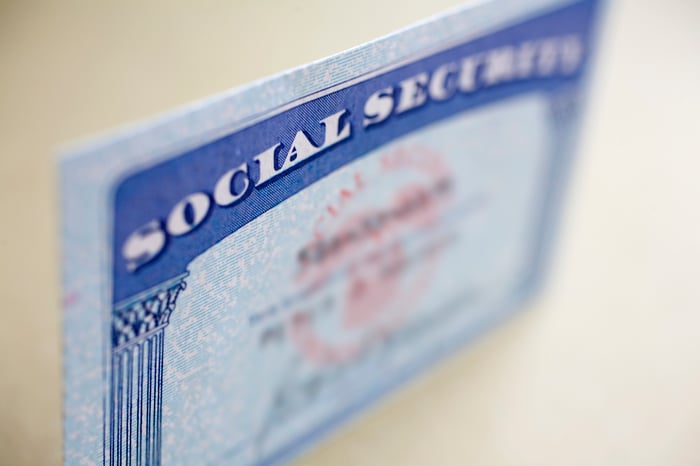 A Social Security card standing up on a tabletop, with the name and number blurred out