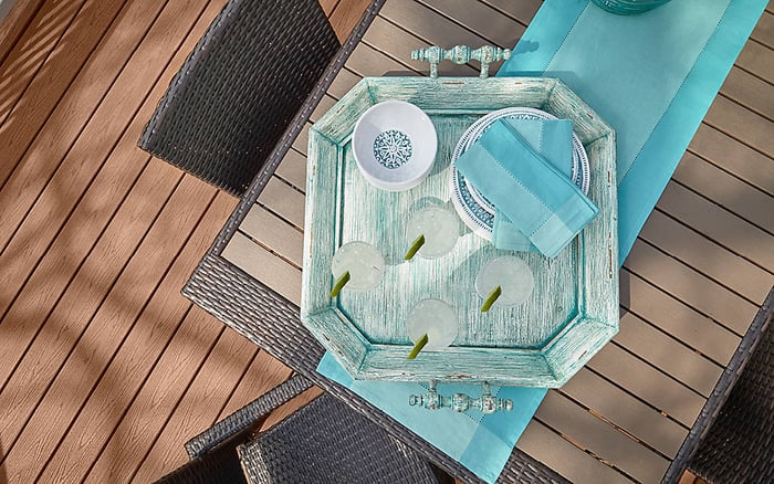 Trex Enhance series decking, shown from above a table bearing a blue wooden tray