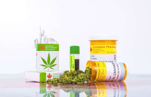 An assortment of legal Canadian cannabis products in their packaging atop a counter.